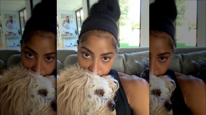 Candace Parker with dog in house