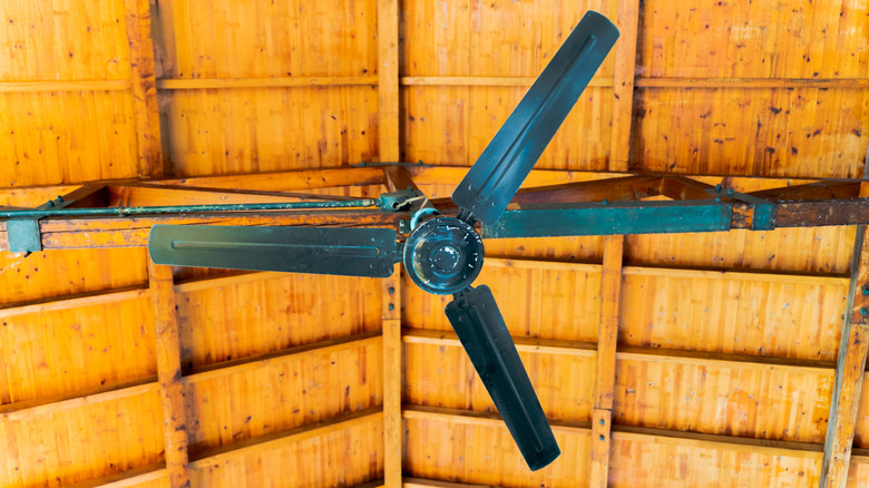 Ceiling fan mounted under wood roof