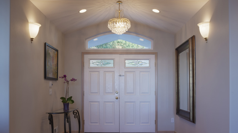 entryway with vaulted ceiling chandelier