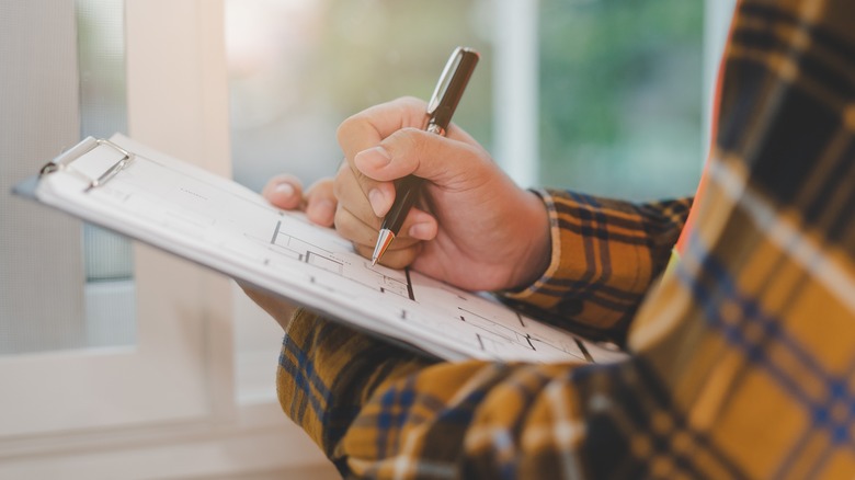 Man with clipboard, concept of home inspection