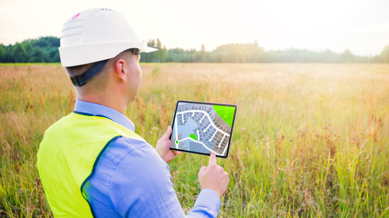 Person with iPad in field 