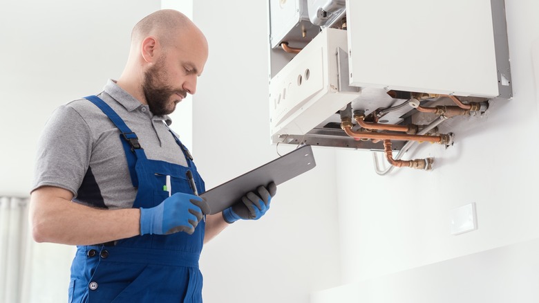 man inspecting appliance