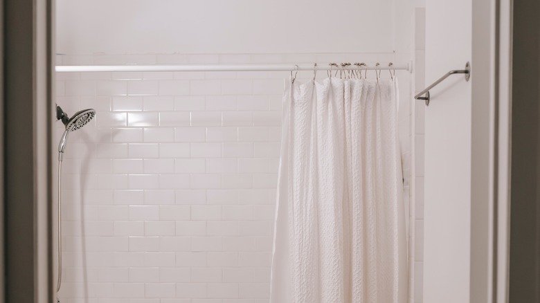 Curved curtain rod in tiled shower