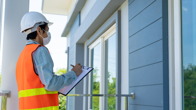 Home inspector documenting house