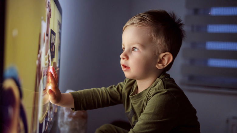 Kid close to TV at night