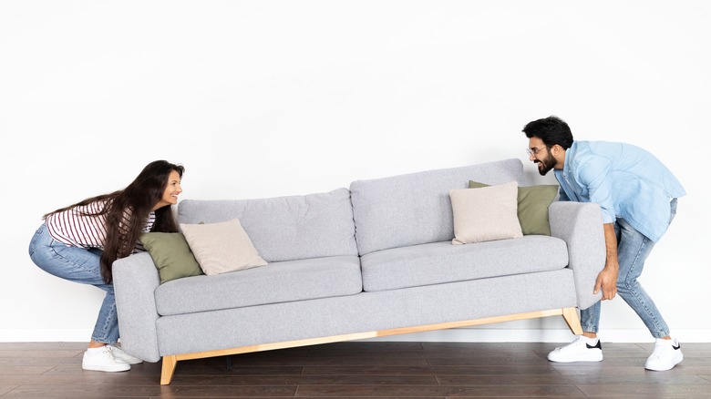 couple moving a couch