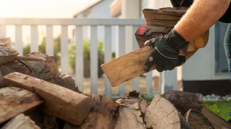 person picking up wood 