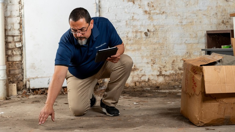 Man inspecting basement floor