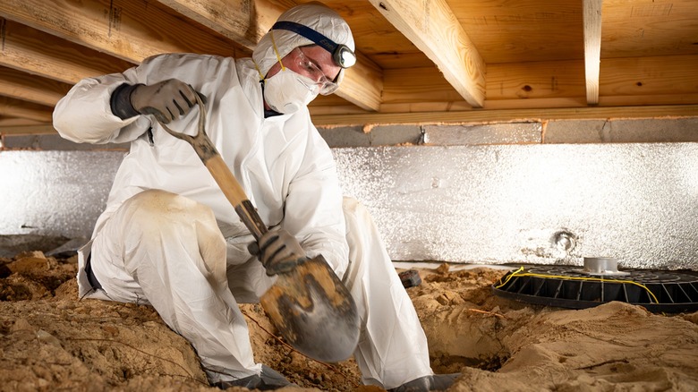 Man digging in crawlspace