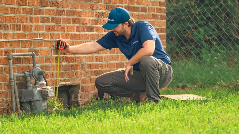 Man inspecting home foundation