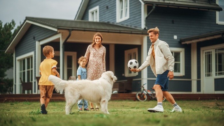 family playing soccer outside