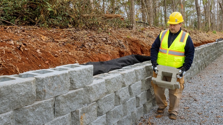 Man building concrete retaining wall