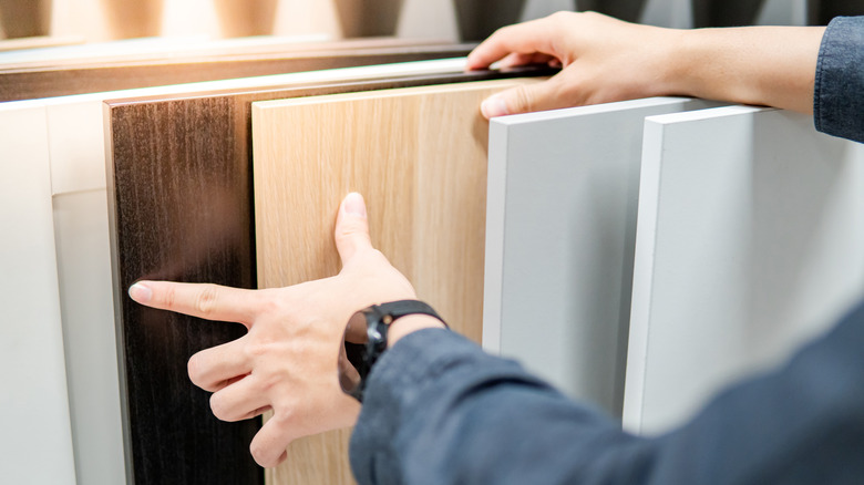 A person looks through hardwood cabinet panels