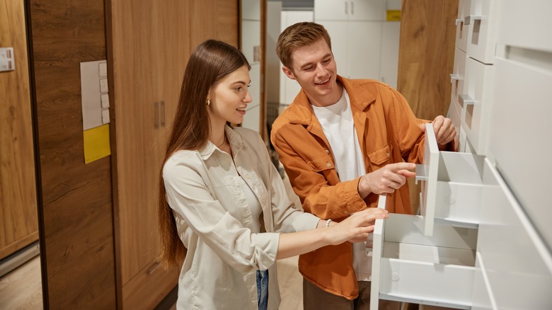 A couple looks at cabinets