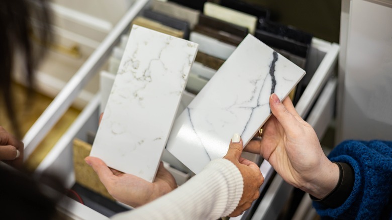 female hands holding countertop samples