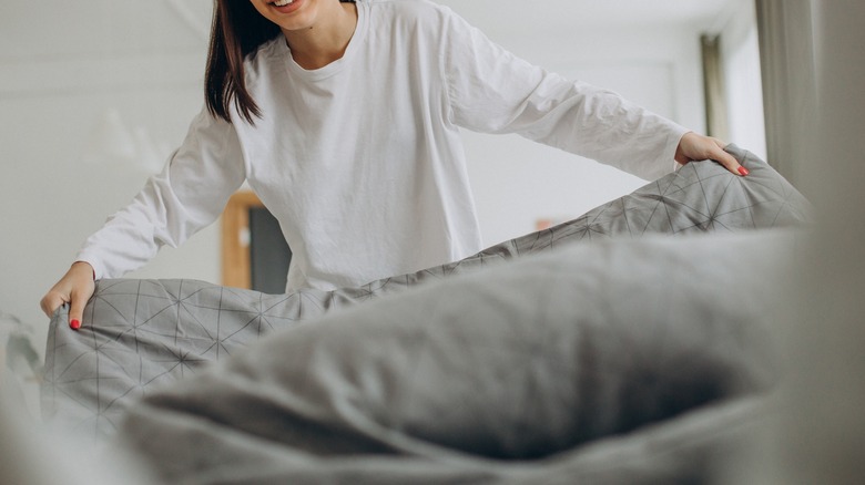 A woman making her bed