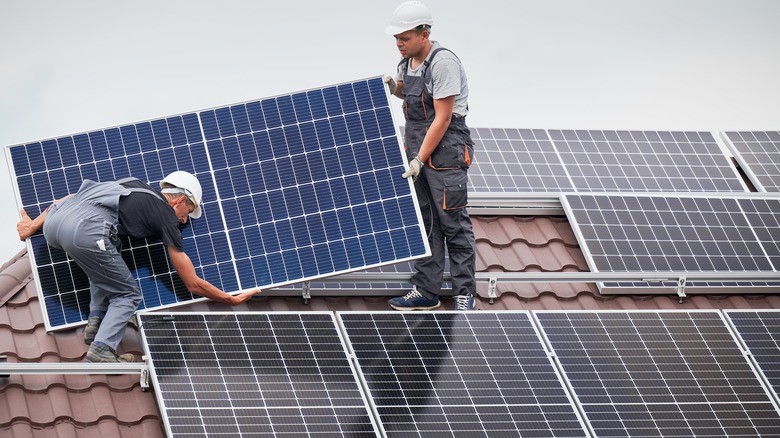 two electricians installing solar panels