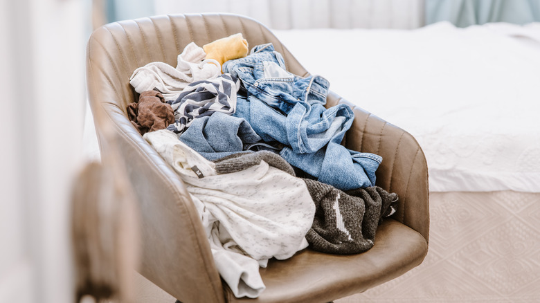 clothes cluttered on chair