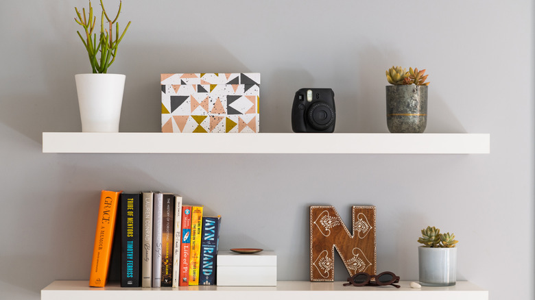 Floating shelves with books and decor pieces