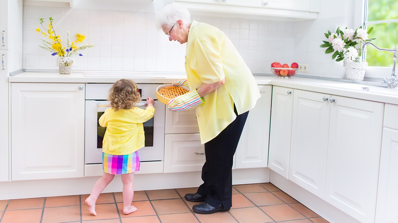 child and grandparent in kitchen