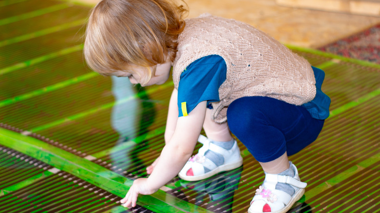 child on radiant heat floor