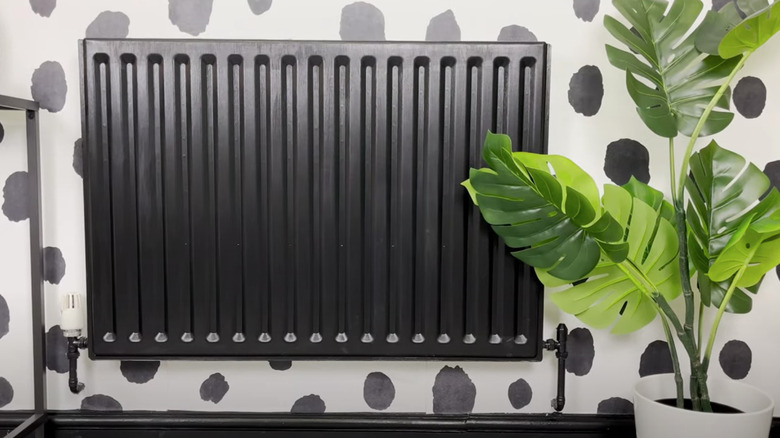 Black radiator with fake plant