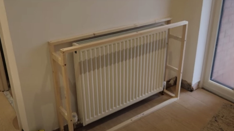 Wooden frame around white radiator