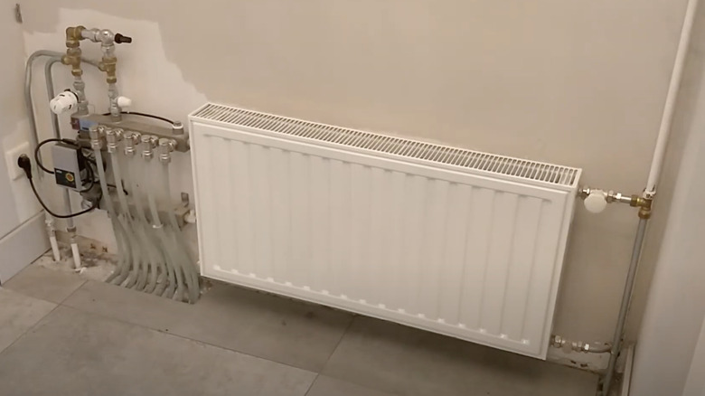 Large white radiator along wall