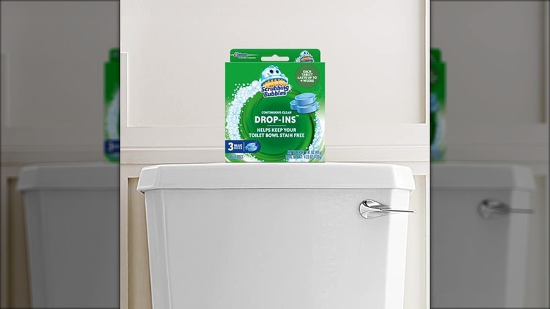 A pack of Scrubbing Bubbles drop-ins sits on a toilet tank