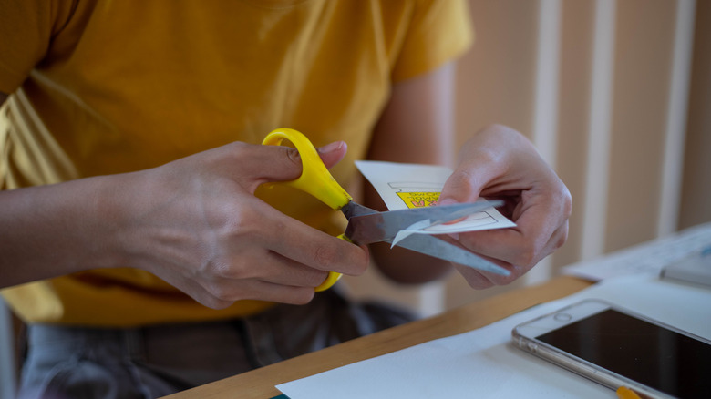 Using scissor to cut paper