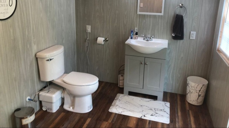 Upflush toilet in bathroom