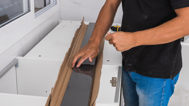 man with pieces of cabinets