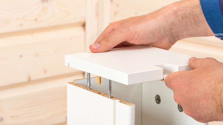 Person assembling cabinets