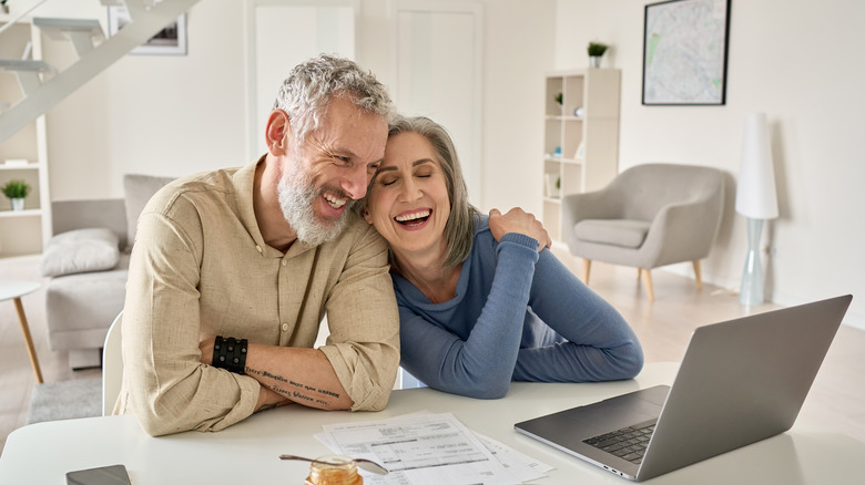 Older couple looking at home value