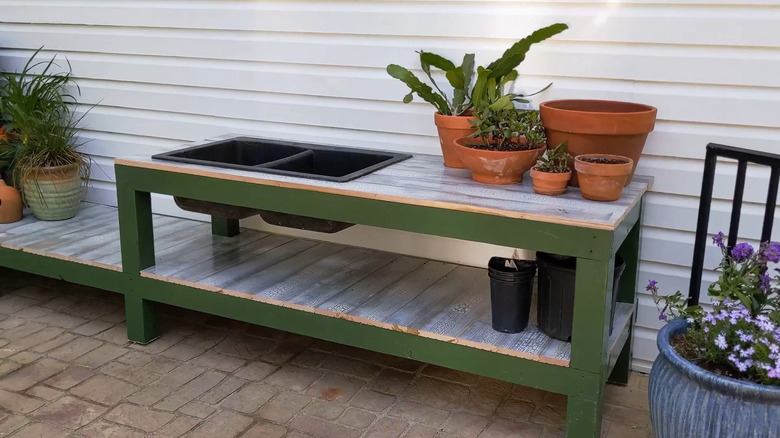 A low potting bench with an integrated two-basin composite kitchen sin