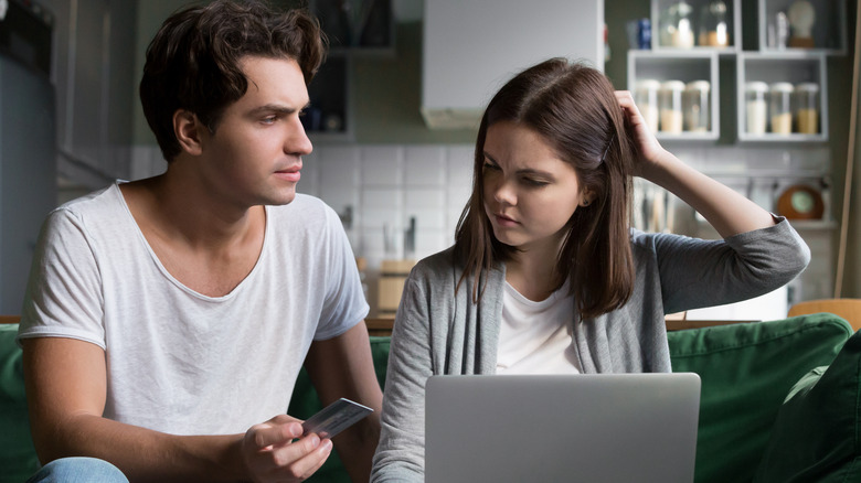 stressed couple with credit card