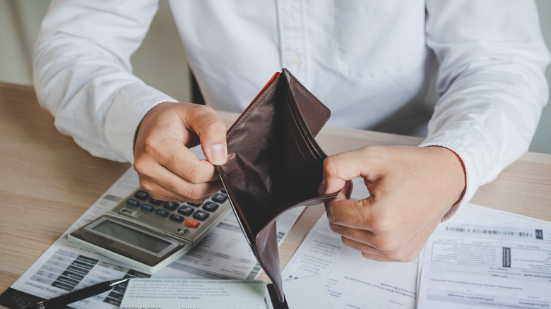 man opening empty wallet