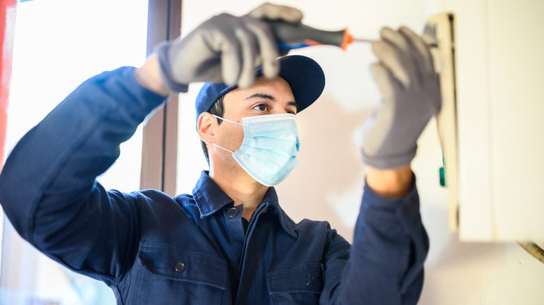 Technician repairing home feature