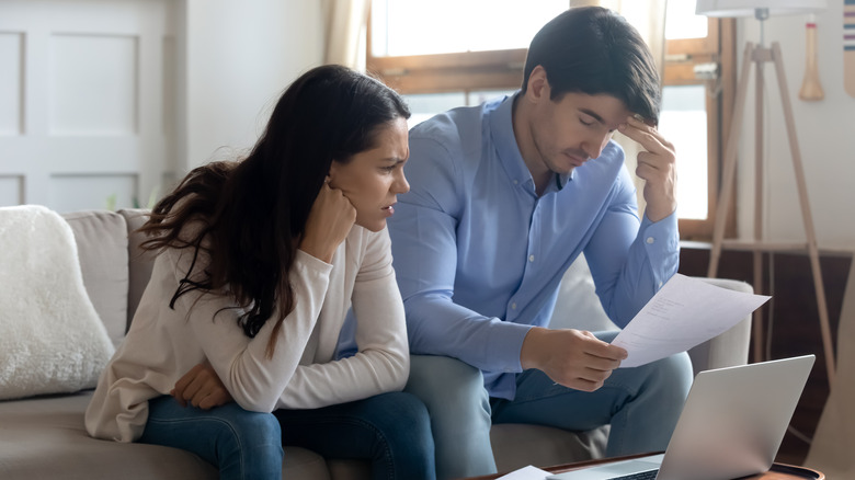 stressed couple looking at documents
