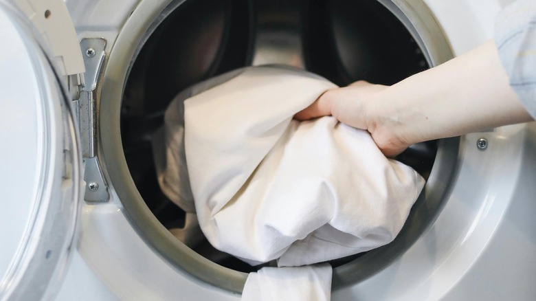 hand reaching into clothing dryer