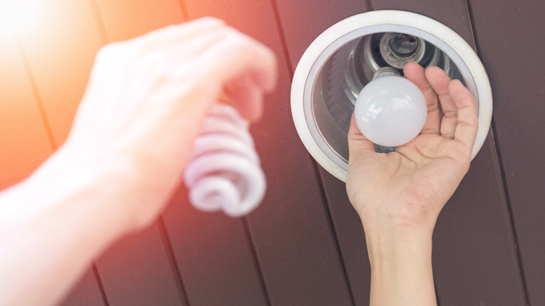 Man changing light bulb