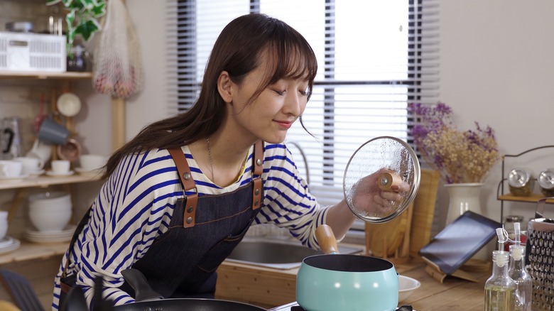 Woman smelling pleasant scent