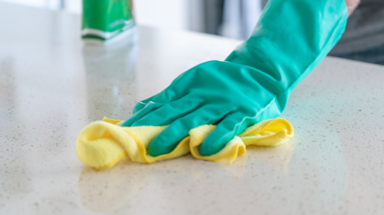 Cleaning countertop with rag