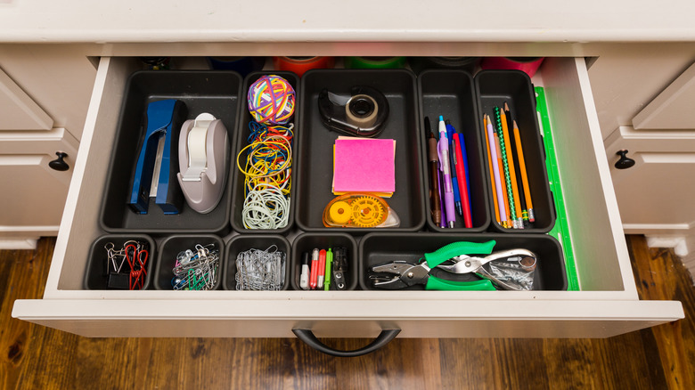 organized items in utility drawer