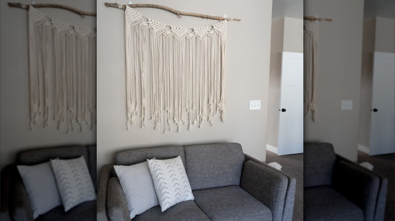 large tapestry above gray couch