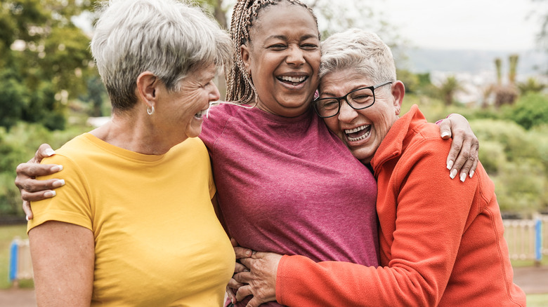 older women laughing and hugging