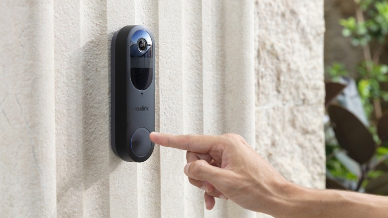 Black battery doorbell mounted outside