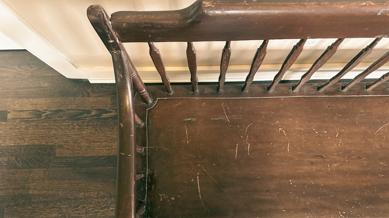 Wood bench with scratches on the seat