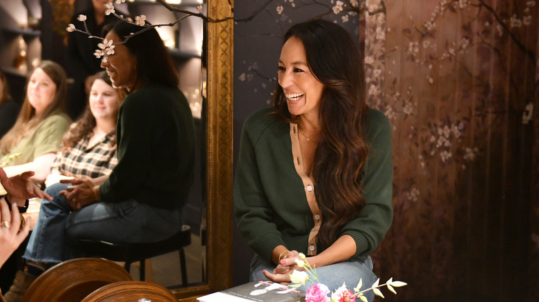 joanna gaines smiling with mirror