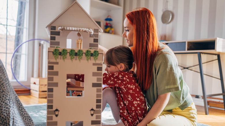 Mother and child with dollhouse